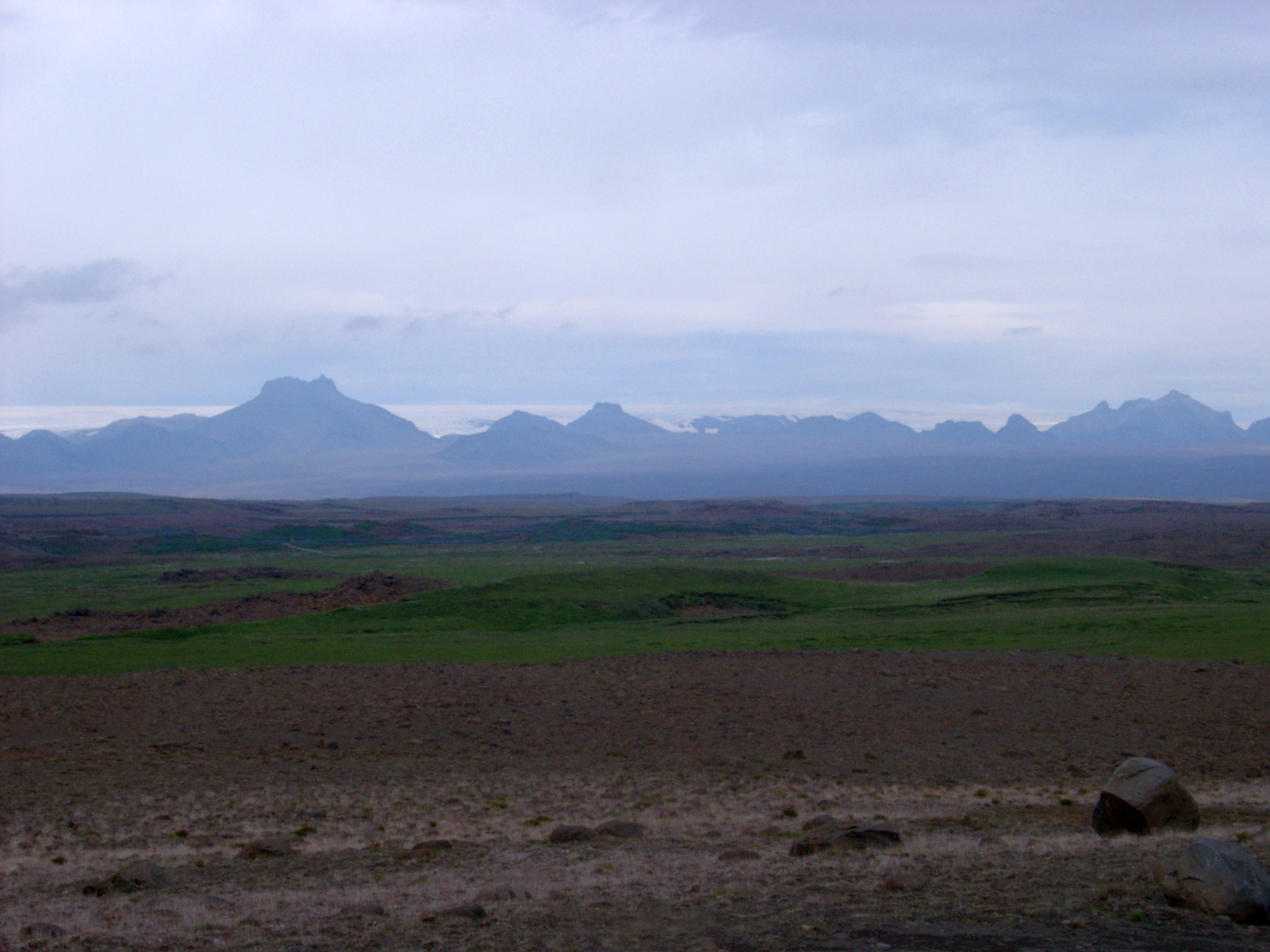 an image of Overcast Sky and Hazy Icelandic Mountain Scenic with Valley in Foreground