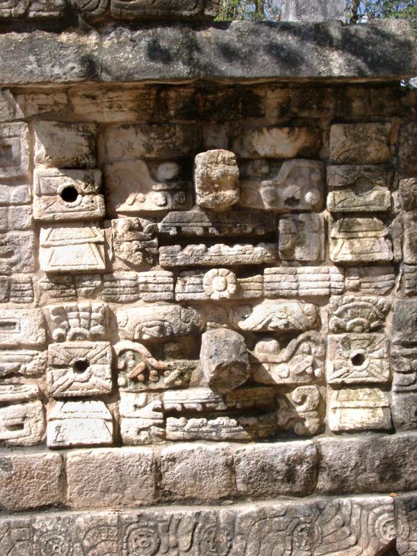 Old carved stone wall with tribal patterns in Chitzen Itza Mayan ruins in the Yucatan Province, Mexico