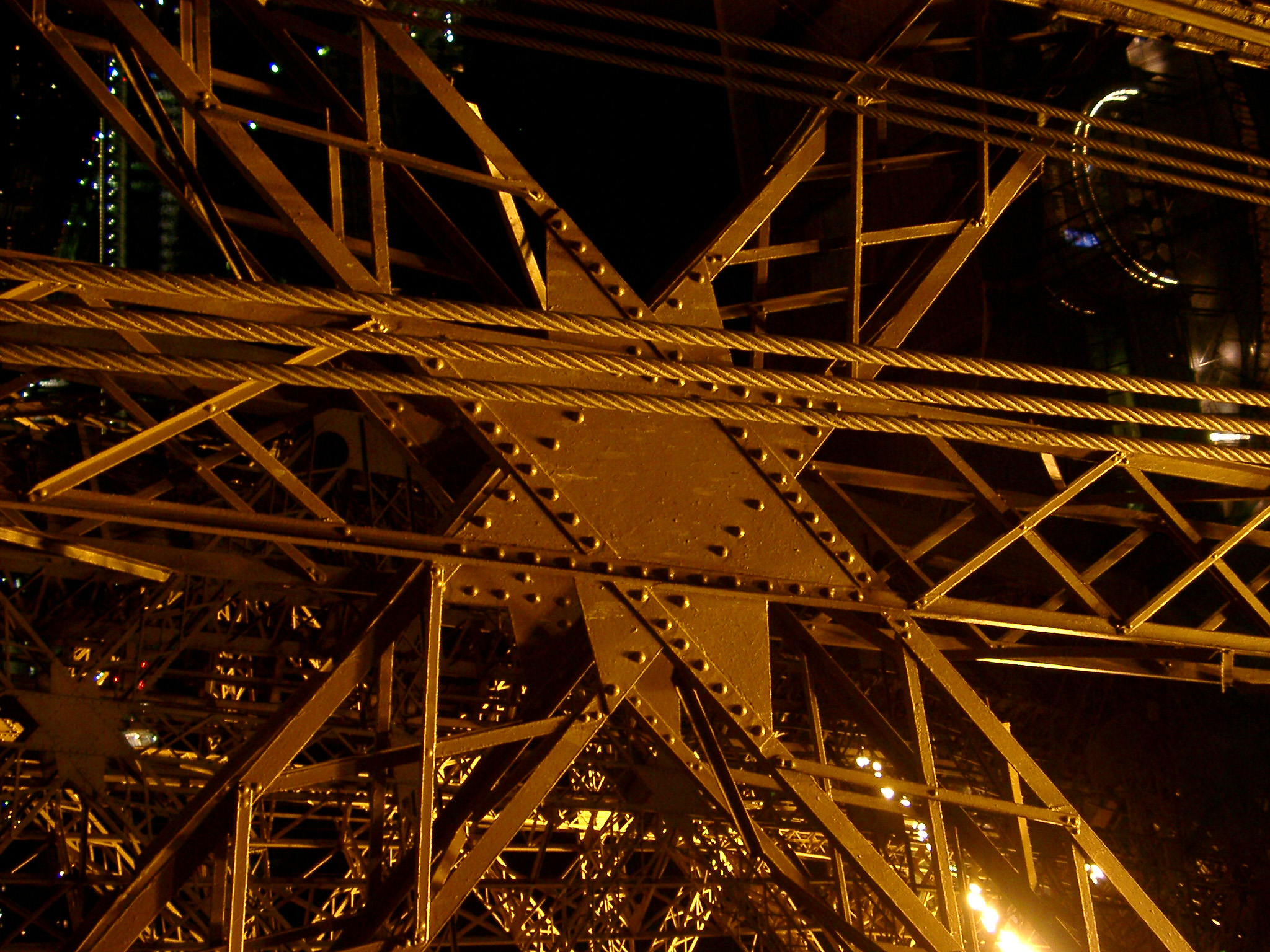 an image of Close Up of Eiffel Tower Iron Lattice Structure with floodlights peeking through, Paris, France