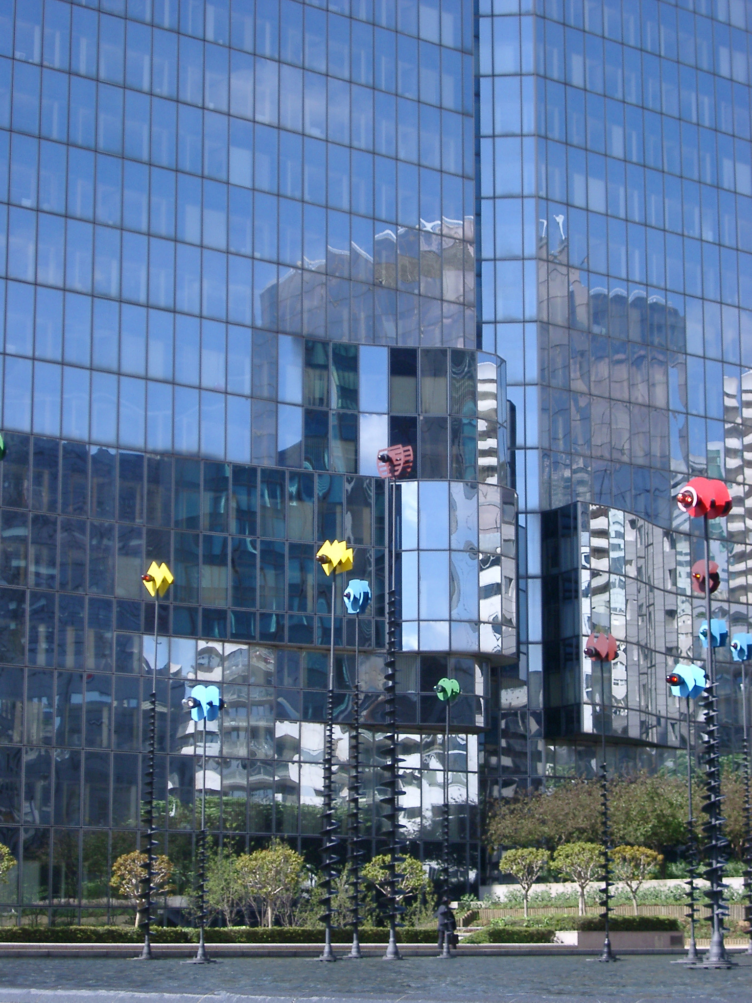 an image of Huge Paris La Defense Shiny Building with Reflections of Other Buildings Nearby.