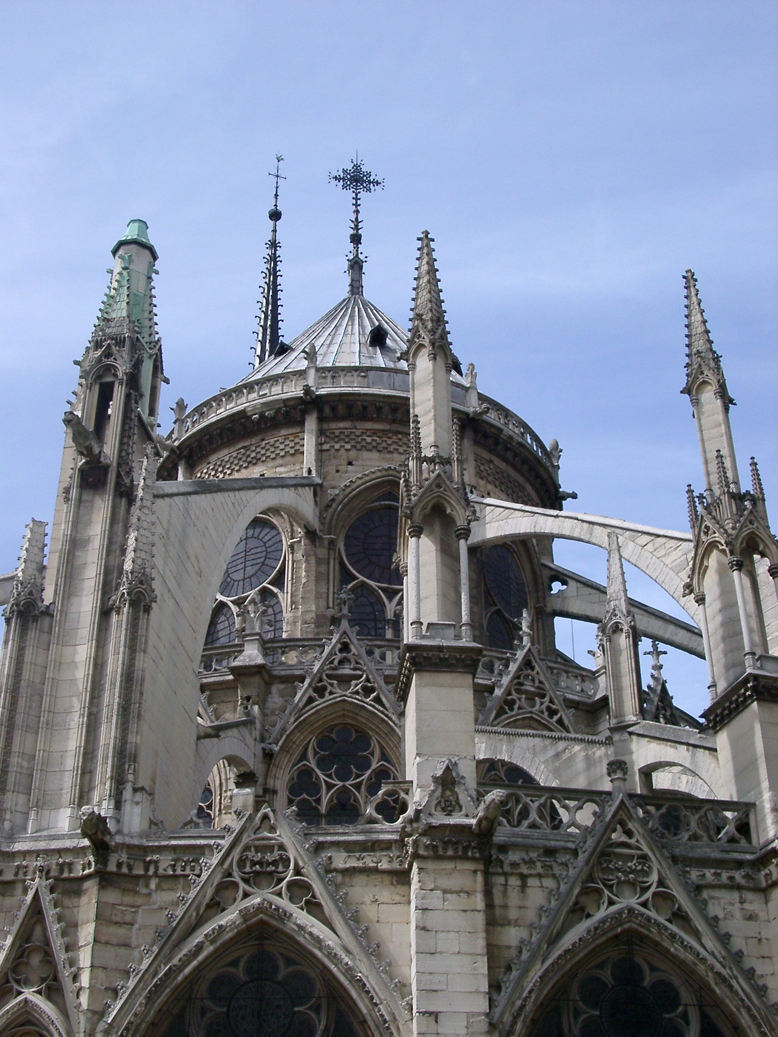 an image of Famous Historic Artistic Notre Dame Church Building. Isolated on Light Blue Sky Background.
