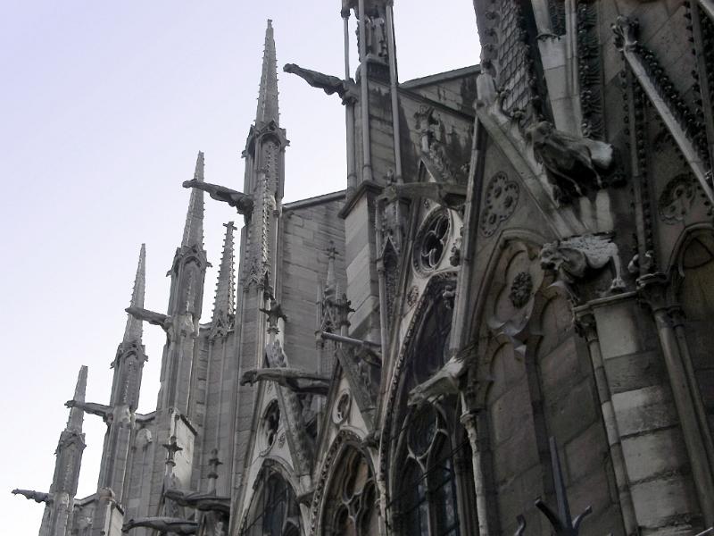 Notre Dame cathedral, Paris showing the delicate spires on the flying butresses and gargoyles along the side of the exterior of the building