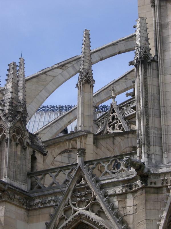Notre Dame Cathedral flying buttress detail showing the arched masonry support directing the thrust from the roof away from a main structure to an outer buttress