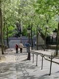 People walking down the long flight of steps leading down from butte Montmarte and the Sacre Couer Cathedral in Paris