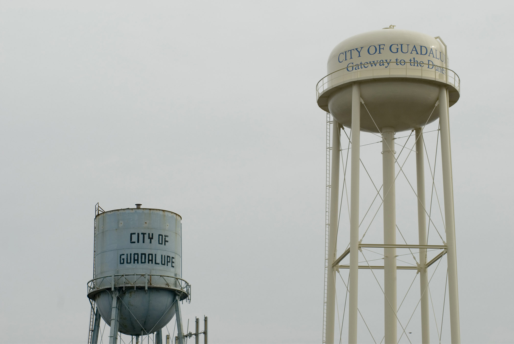 an image of Two Water Towers Over City of Guadelupe in California, USA