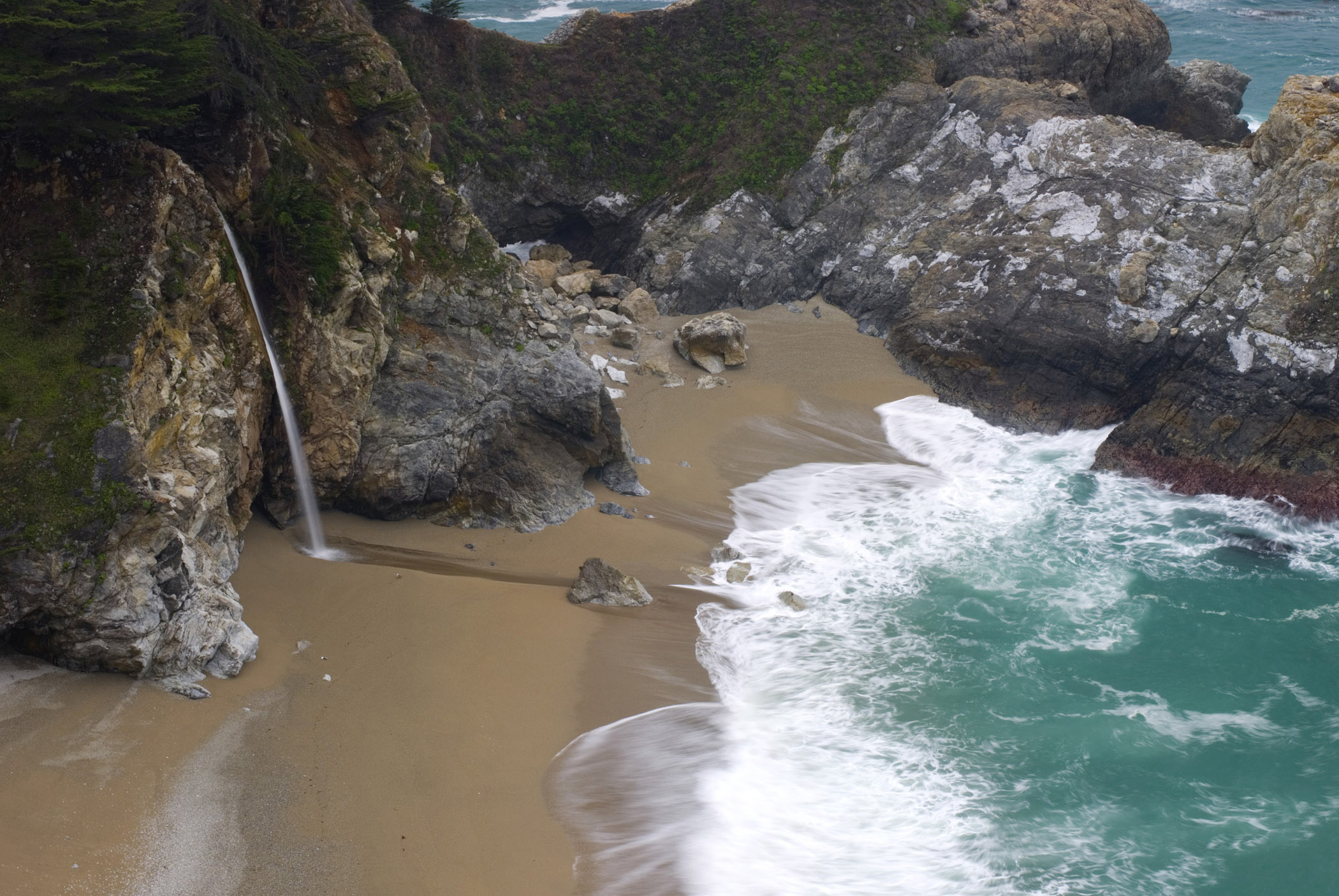 an image of Beautiful McWay Falls in Front the Blue Water Sea in Aerial View