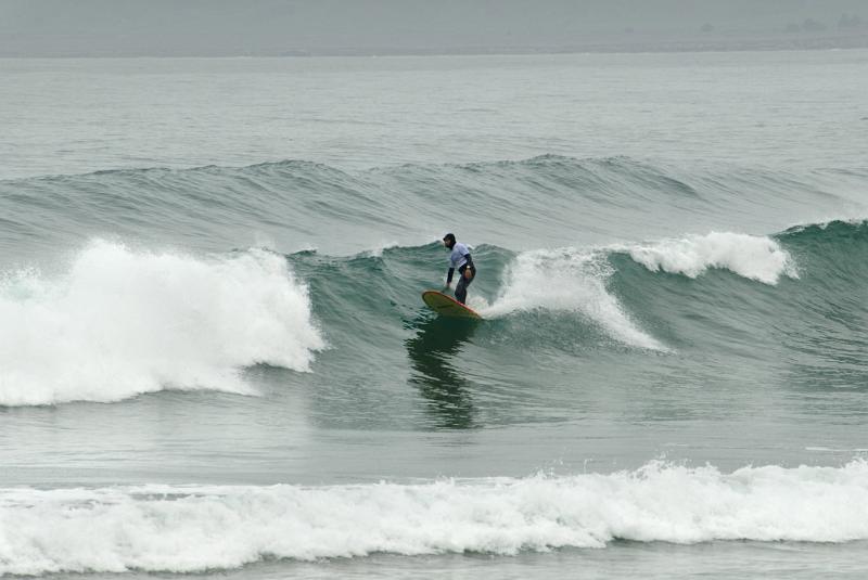 Solo Tourist Winter Surfer at Beautiful Morro Bay. Perfect Place for Vacation.