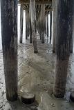Underneath Old Wooden Columns at Cayucos Pier in California