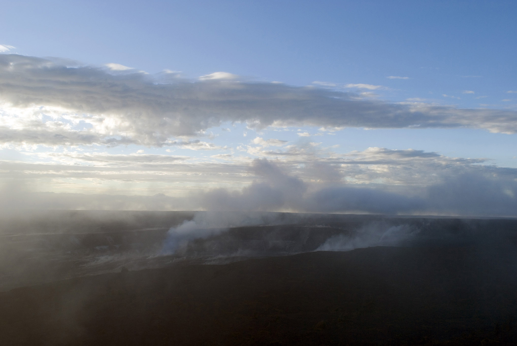 an image of Overview of Steam Vents in Volcanoes National Park, Hawaii in Early Morning or Late Afternoon Sunlight