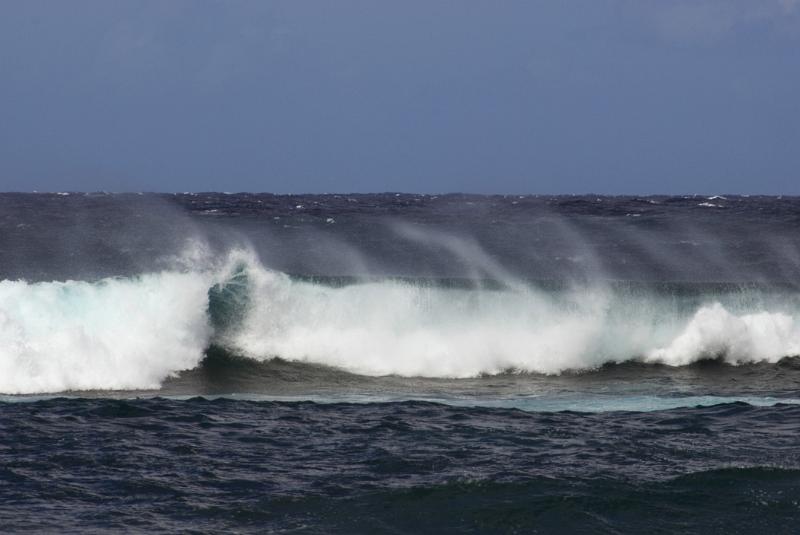 Big waves off the North Shore, Hawaii with spray whipped up by the wind, a popular area for surfers