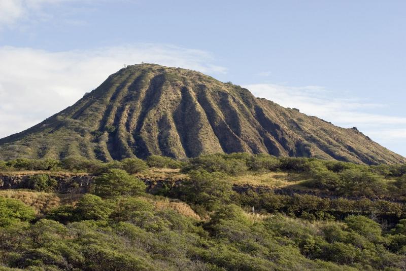 spot of Grassy Koko Head Crater Trail in Extensive View. Isolated on Light Blue Sky Background.