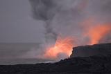 Red hot lava exploding from a volcanic fissure in an eruption on an active volcano on Hawaii, USA