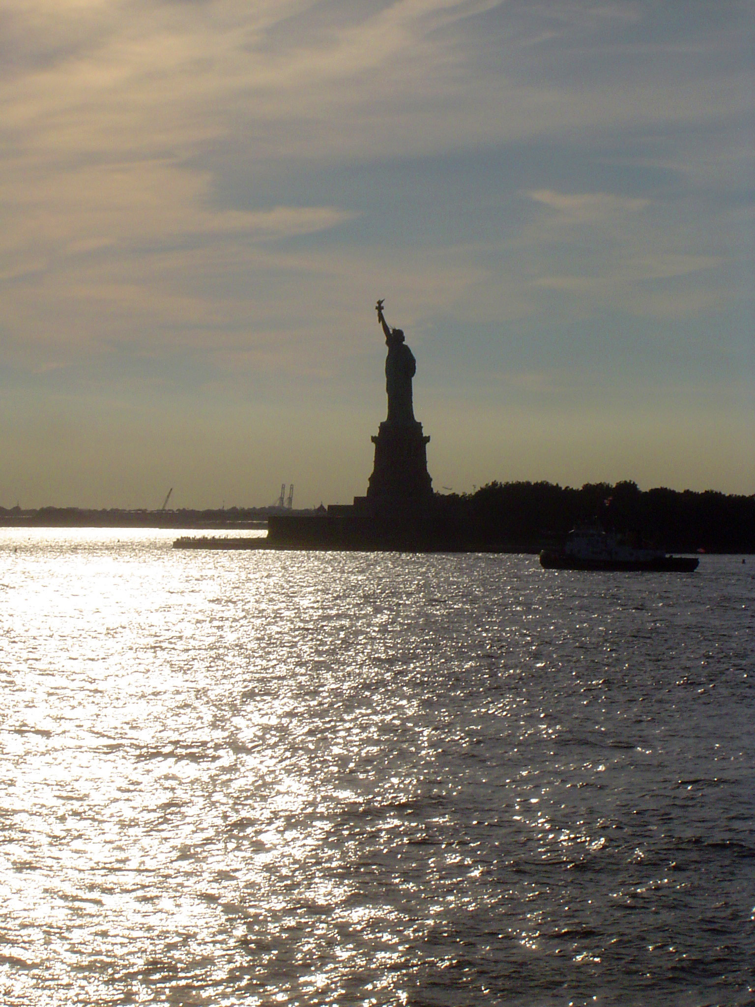 an image of Silhouette Famous Liberty Statue During Sunset Time.