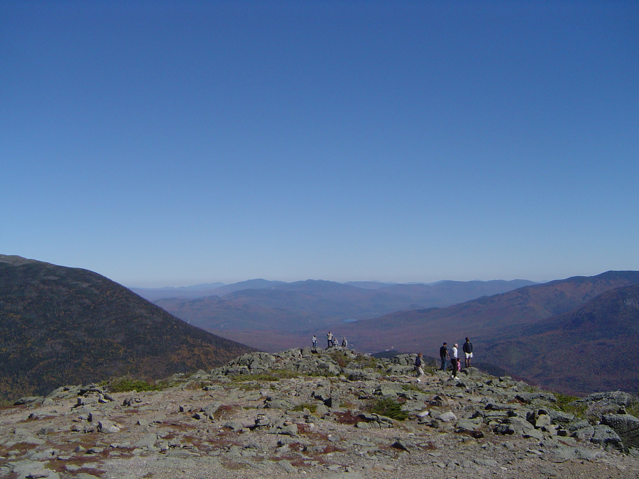 an image of Tourists at Huge Mountains Isolated on Gradient Blue Sky Background.