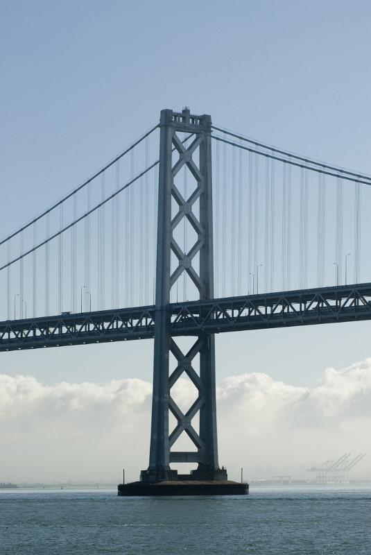 View across the water of one of the support towers of San Francisco Bay bridge a landmark steel suspension bridge in San Francisco, California