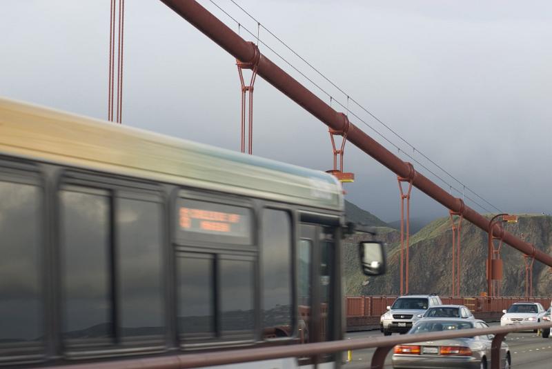 Traffic on the Golden Gate bridge, California driving with headlights on a misty overcast day