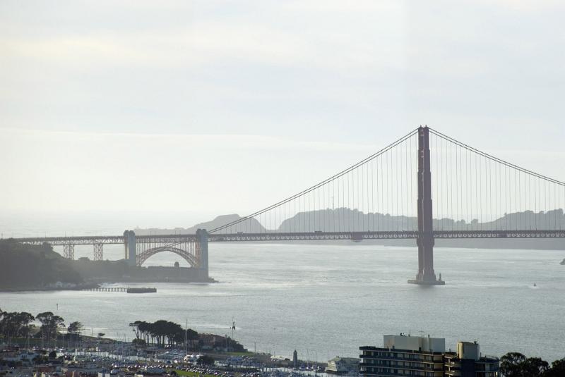 Famous Golden Gate Bridge in San Francisco Famous Long Golden Gate Bridge in San Francisco. Against a Very Light Blue White Sky Background.