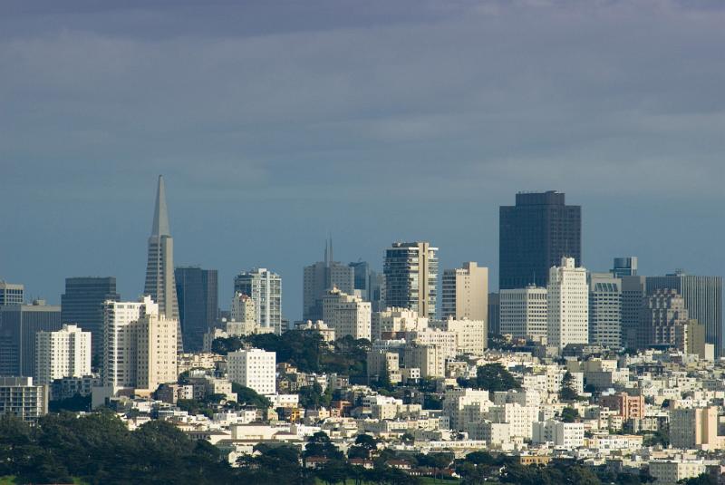 San Francisco skyline and cityscape on a blue sky hazy day showing the modern architecture and skyscrapers of the CBD