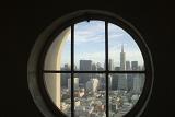 View of San Francsico from The Lilian Coit Memorial Tower looking through a round window at the CBD