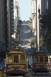 Trams passing each other on a steep urban street in Nob Hill,an affluent neighbourhood of San Francisco, California, USA