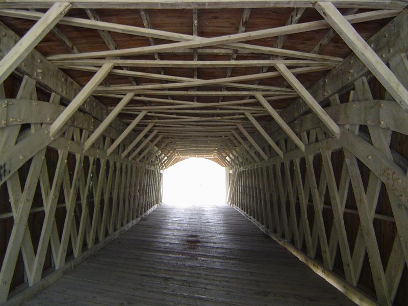 View through the interior length of an old wooden covered bridge in Madison County, Iowa, USA