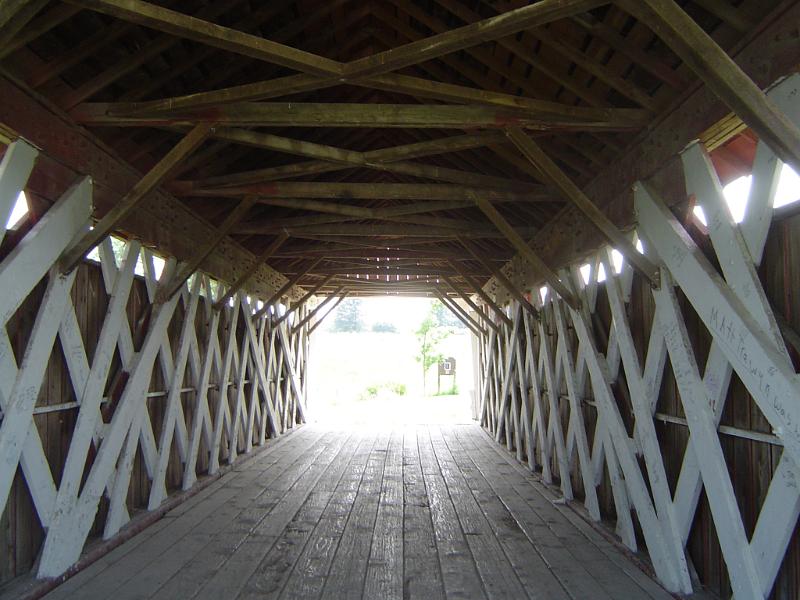 Interior of a historical American covered wooden bridge in Madison County showing the lattice framework