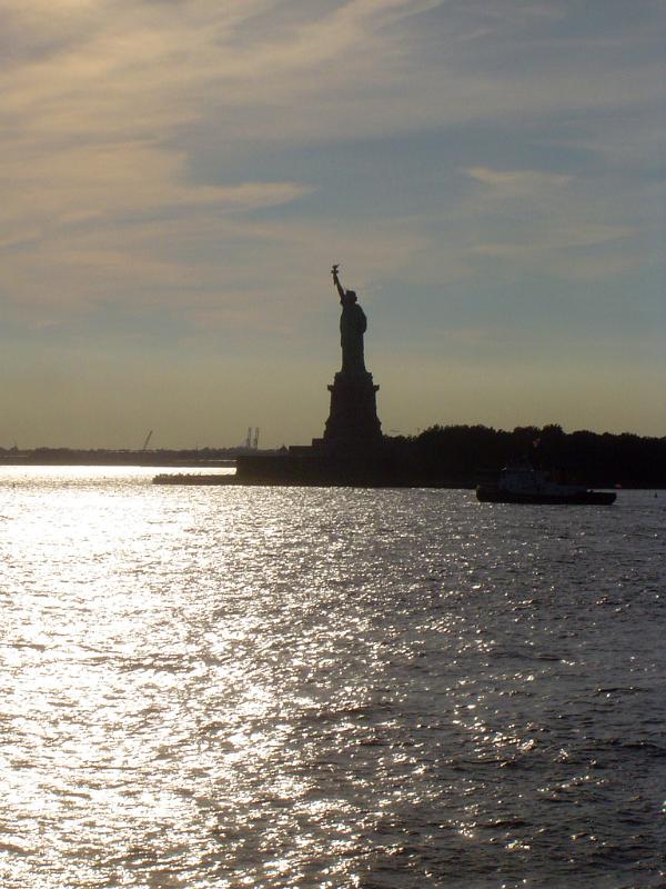 Silhouette Famous Liberty Statue During Sunset Time.