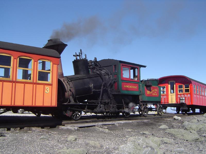 Vintage Locomotive on Cog Railway Close up Running Vintage Steam Locomotive on Cog Railway. Captured on Gradient Light Blue Sky Background.