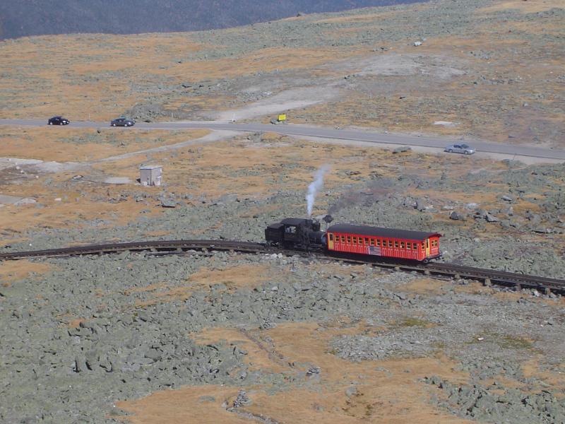 Mount Washington Cog Railway Mount Washington Cog Railway traversing a steep slope with a single carriage carrying tourists on a sightseeing tour