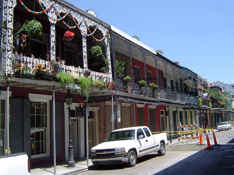 Vintage Architectural Building with Floral Decorations at New Orleans on Light Blue Sky Background