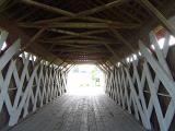 Interior of a historical American covered wooden bridge in Madison County showing the lattice framework