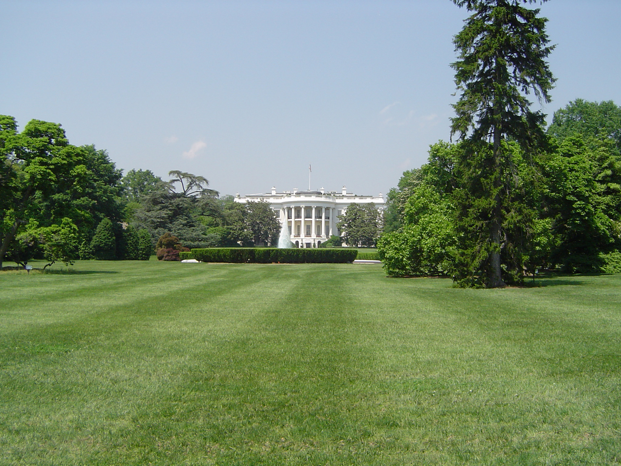 an image of View across manicured lawns of the exterior facade of The White House, Washigton DC, USA