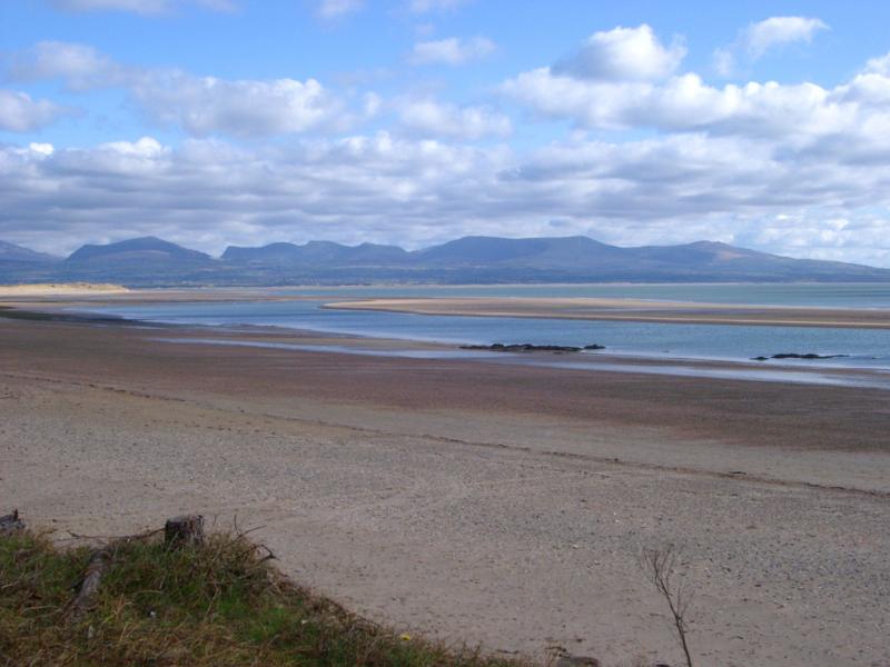Beautiful Tranquil Panorama View from Famous Snowdonia at National Parks in Wales on a Cloudy Sky Above.