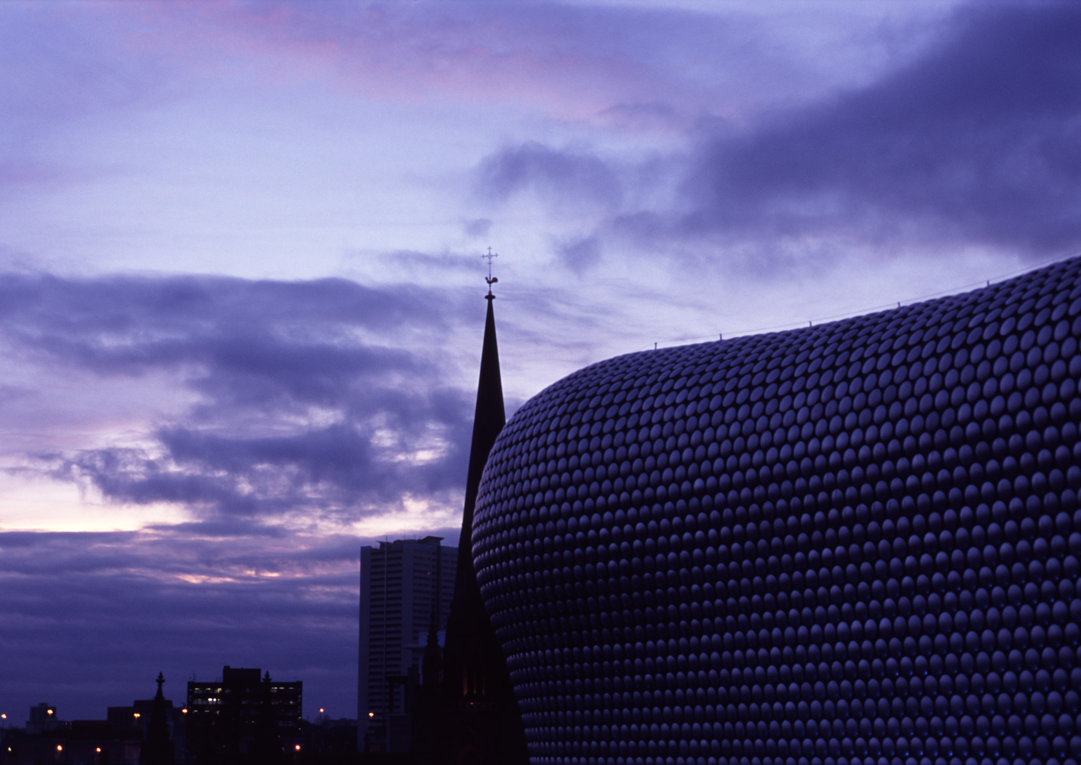 an image of Famous Landmark in Birmingham, England - Bullring Shopping Centre, Emphasizing Selfridges Building. Captured at Night Time.