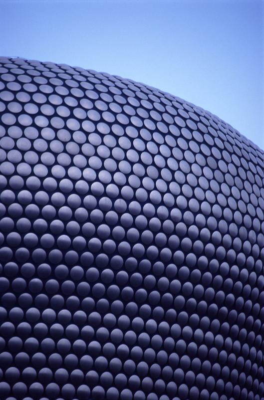 Exterior of the new Bullring Shopping Centre, Birmingham with its distinctive curved architectural design against a blue sky