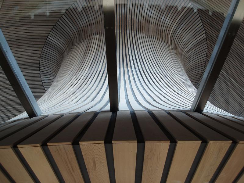 Interior of the Senedd, Cardiff, Wales showing the architectural design of the debating room of the Welsh National Assembly
