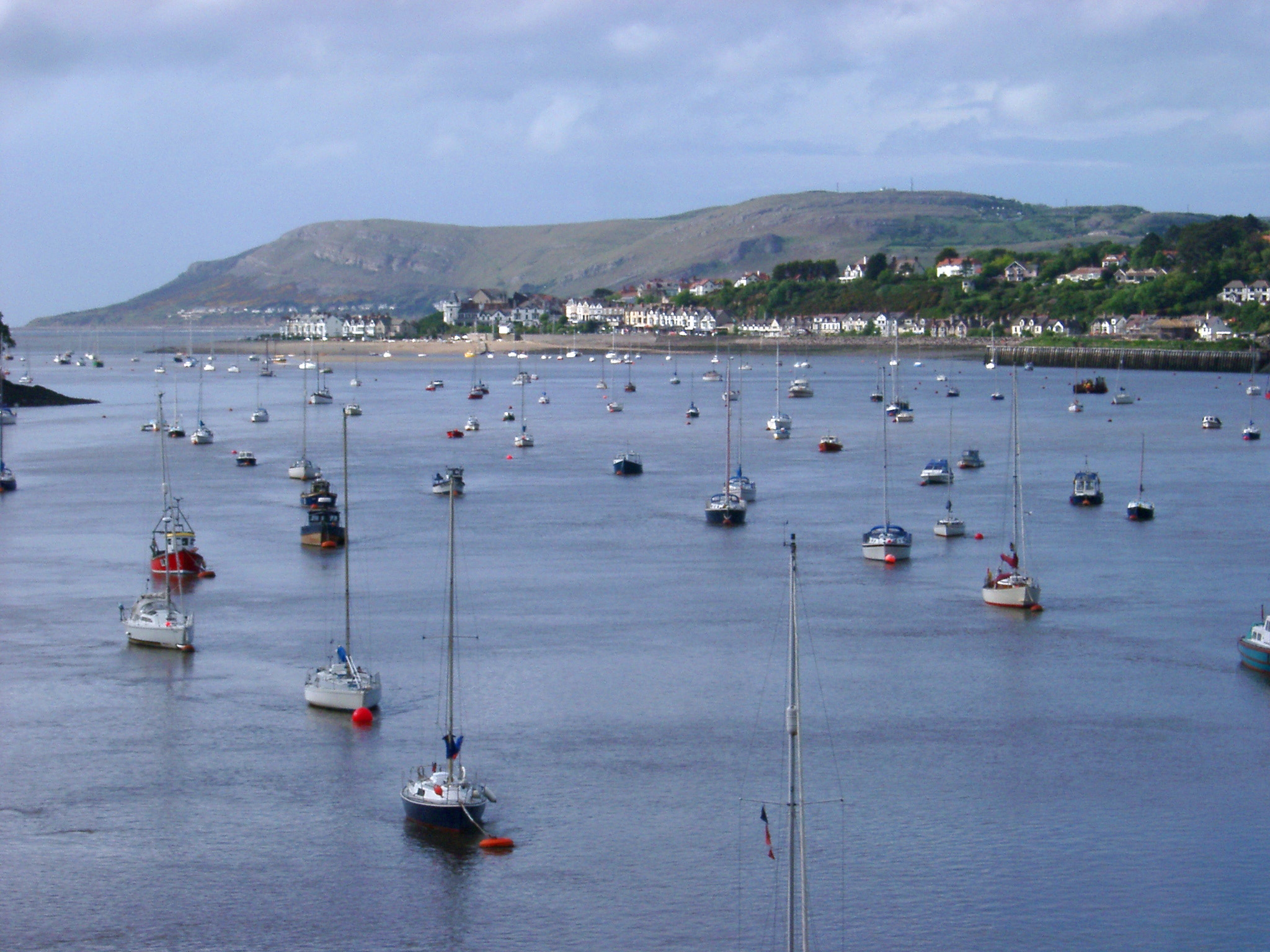 an image of Various Small Boats at Anchor at Famous River Conwy, Wales. Captured with Mountains View Afar.