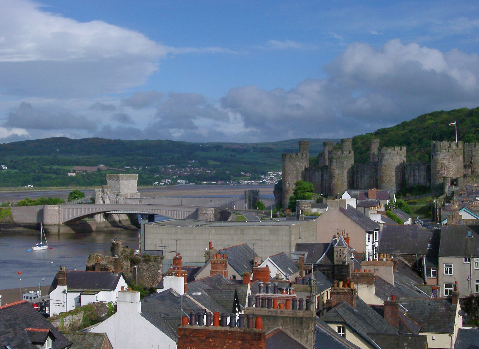 an image of Panorama View of Various Building Rooftops and Ancient Medieval Castle at Conwy, Wales.