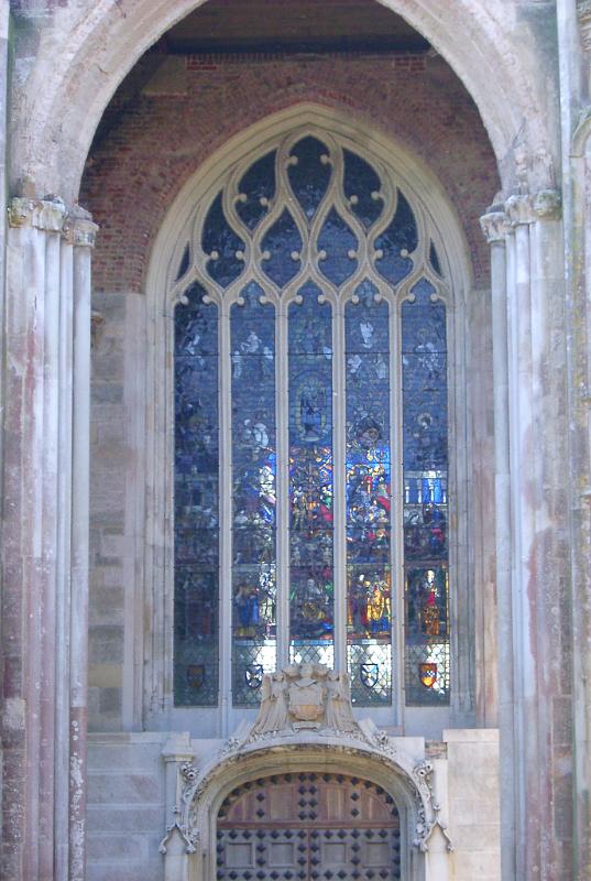 gothic revival style door and large stained glass window