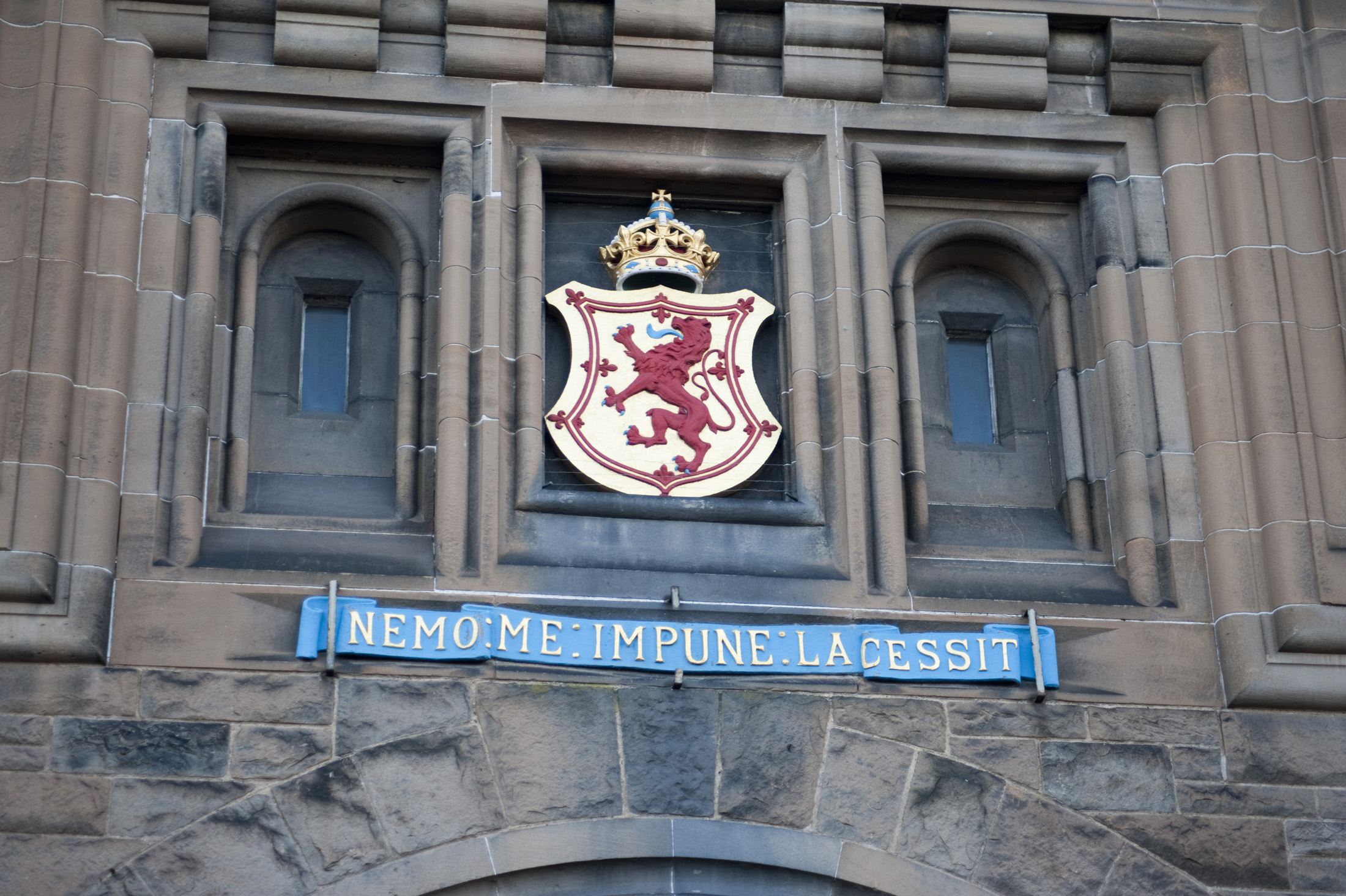 an image of Coat of Arms Shield on edinburgh castle reading nemo me impune lacessit