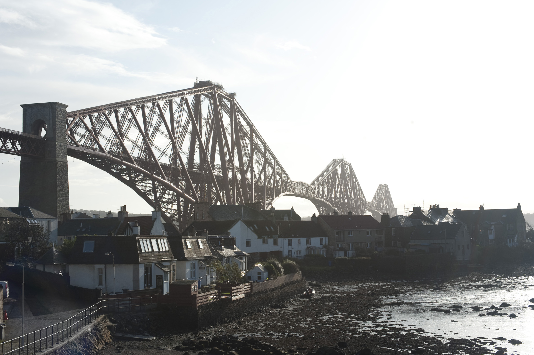 an image of small settlement of north queensferry dominated by the structure of the forth rail bridge