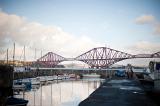 boats in the harbour with the iconic forth rail bridge in the background, queenferry, scotland