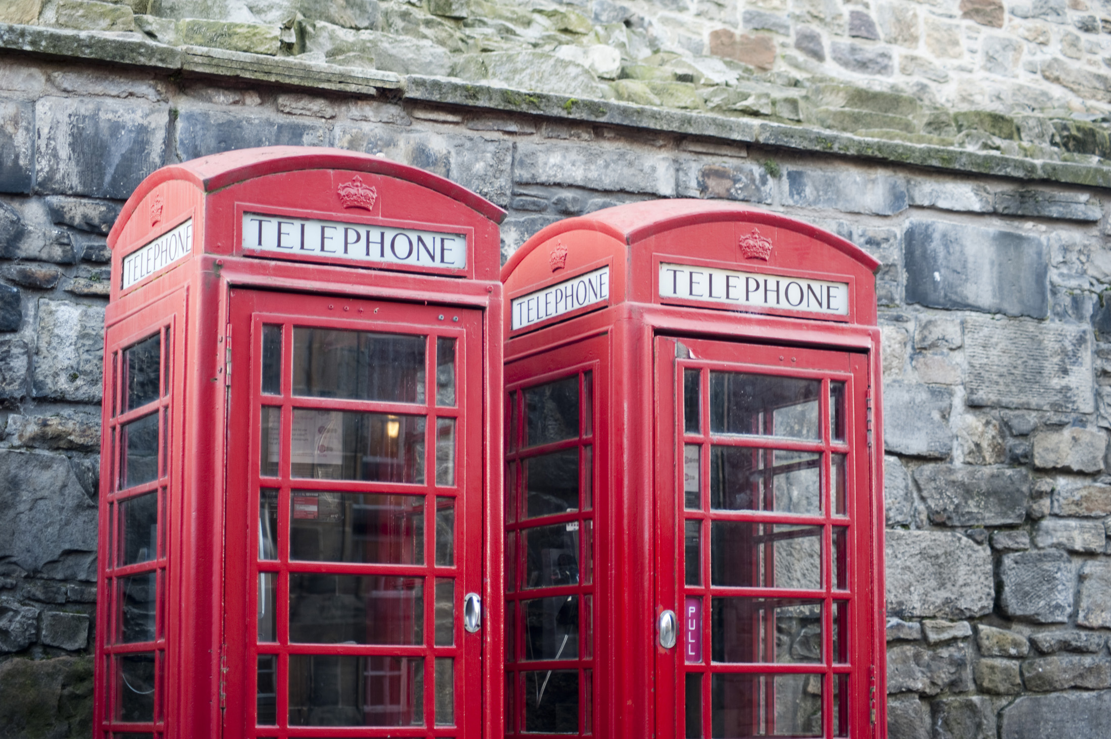 an image of Iconic red UK telephone boxes at edinburgh castle