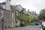 Pleasant Scottish city of Saint Andrews with vines growing on the side of the stone buildings