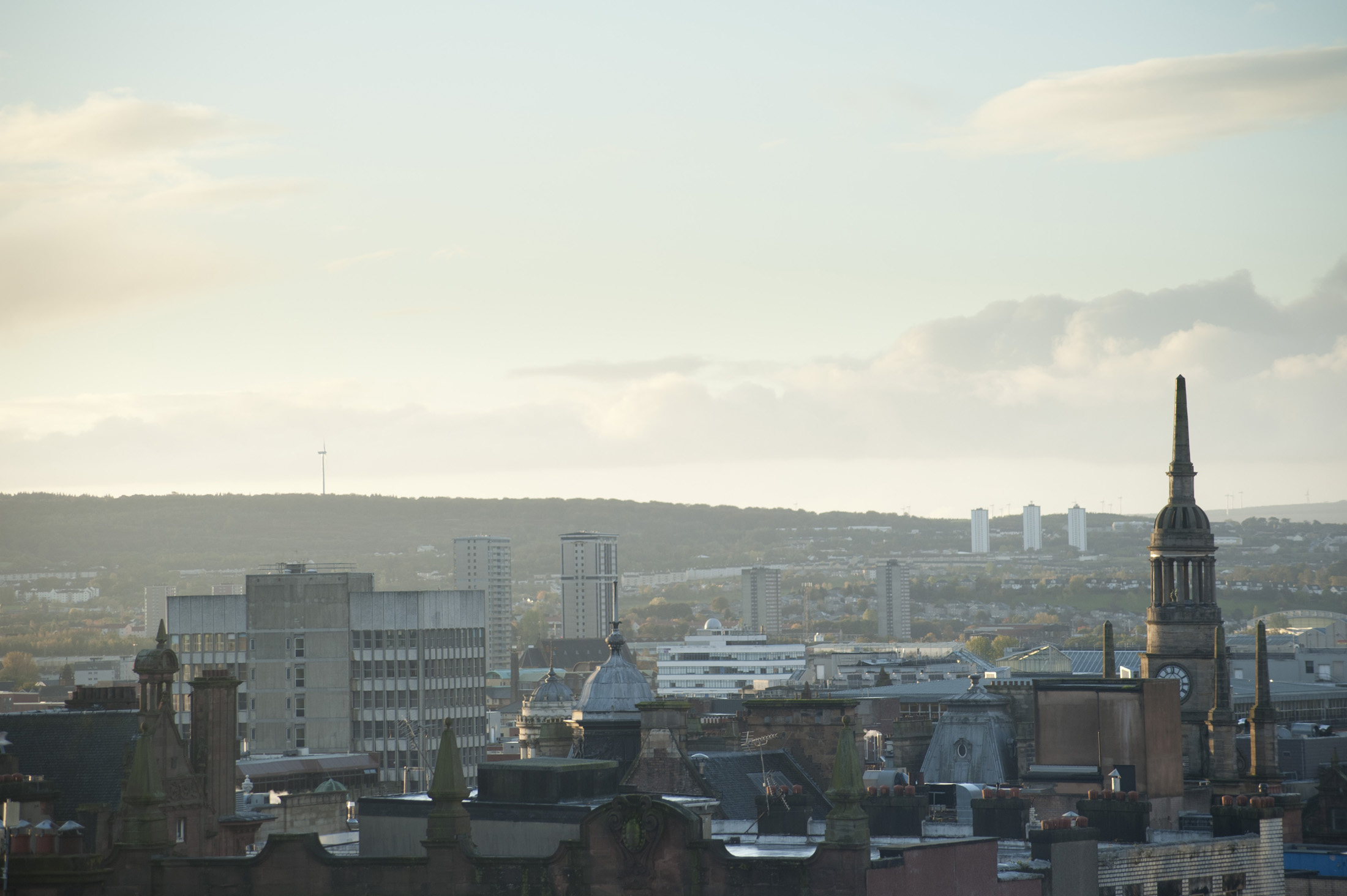 an image of Glasgow skyline with a view over the rooftops of the city on a misty day
