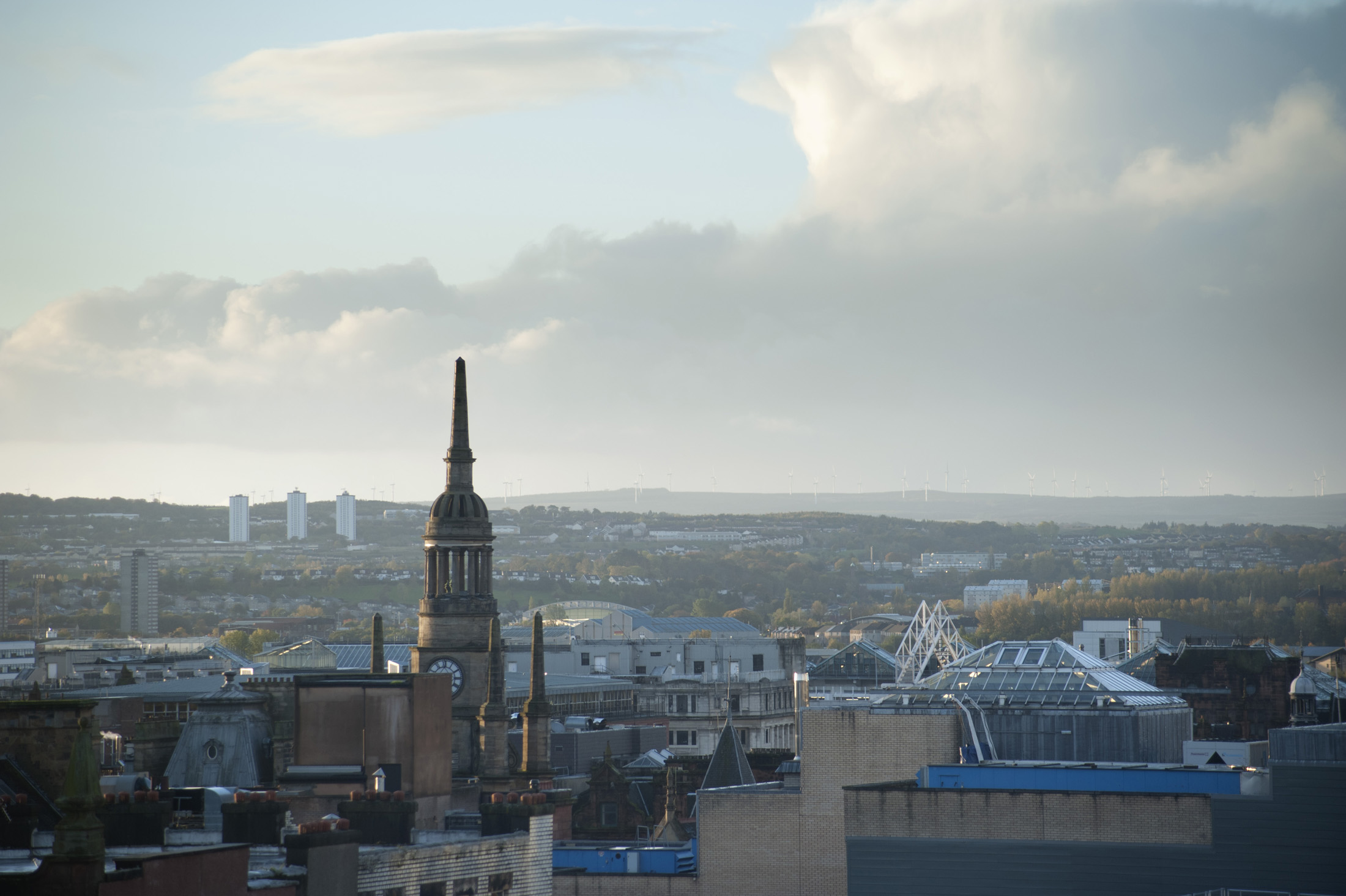 an image of Glasgow skyline with a view across the rooftops of the city on a cloudy day