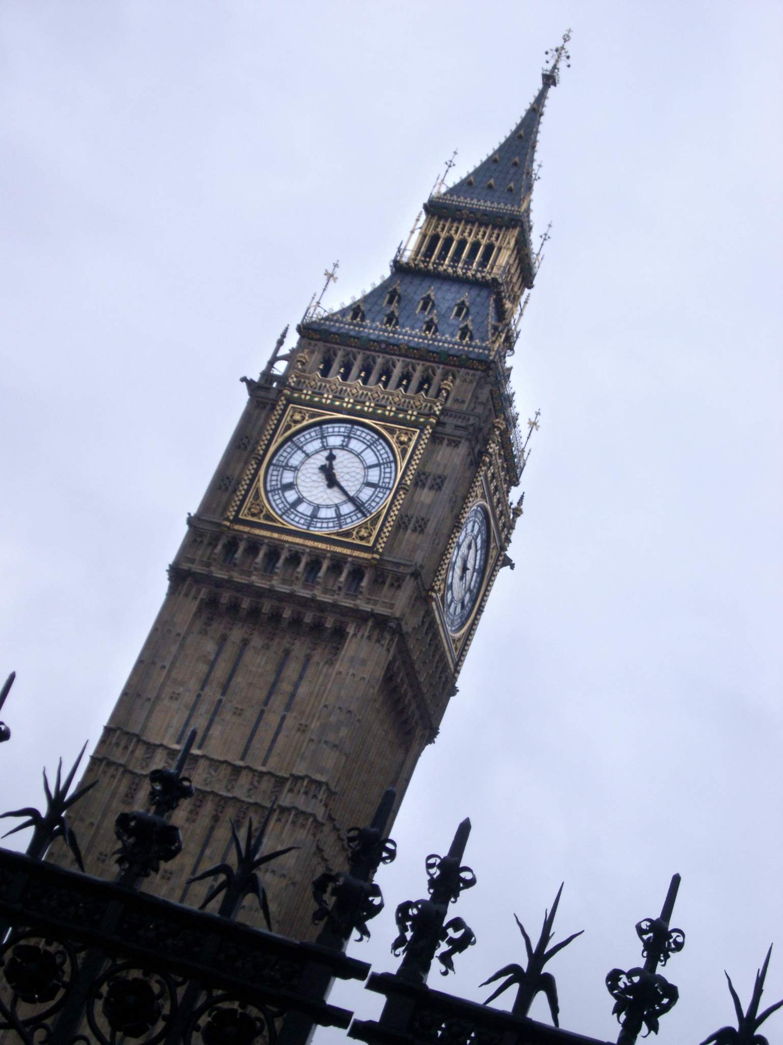an image of The Elizabeth Tower, or clocktower of the old Westminster Palace, London with its ornate Gothic facade and four clock faces or dials , also known as Big Ben and a popular tourist attraction