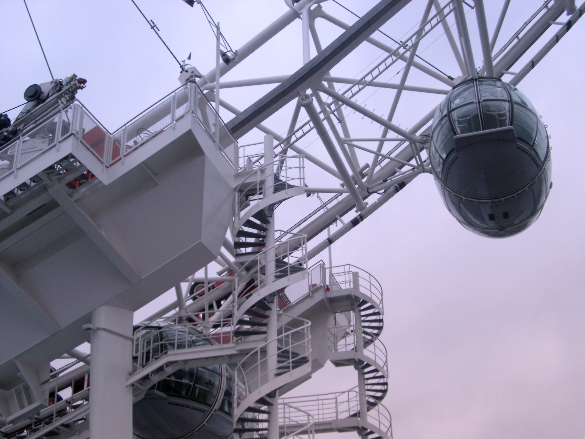an image of Detail of the London Eye ferris wheel, London showing the boarding platform and ovoid passenger capsule for viewing the topography of the city