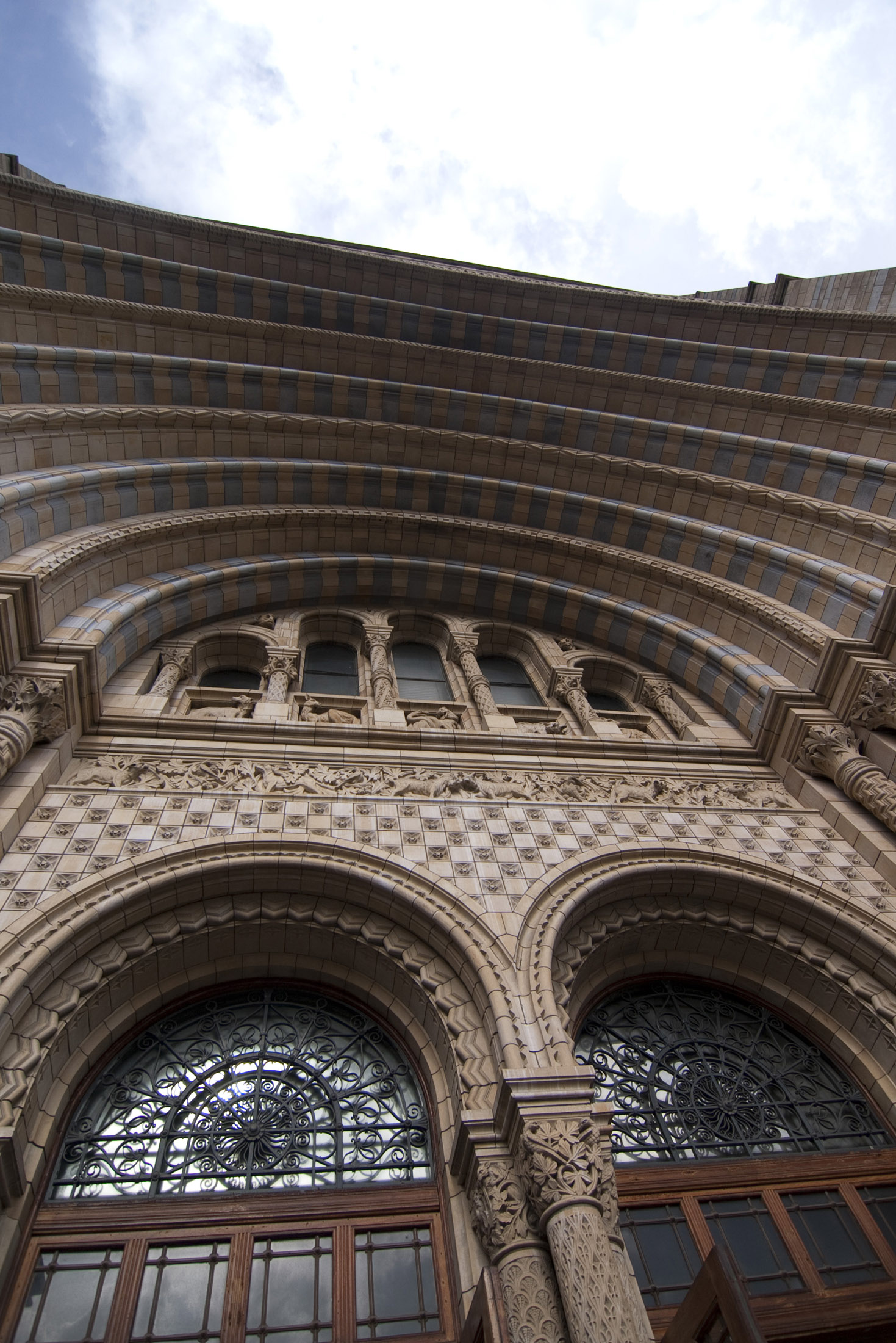 an image of Romanesque style grand entrance to londons natural history museum by architect Alfred Waterhouse