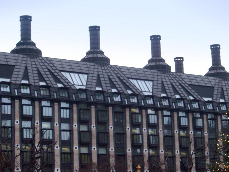 Exterior View of Portcullis House in Westminster, England on Very Light Blue Sky Background.